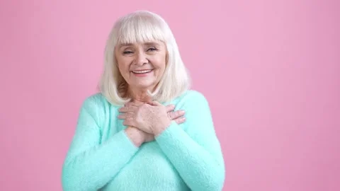 Candid old lady put hands chest heart harmony isolated pastel color background Stock Footage 169288899