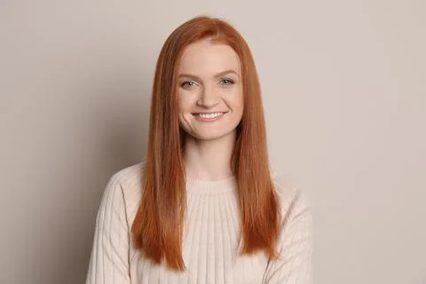 Candid portrait of happy young woman with charming smile and gorgeous red hai Stock Photos