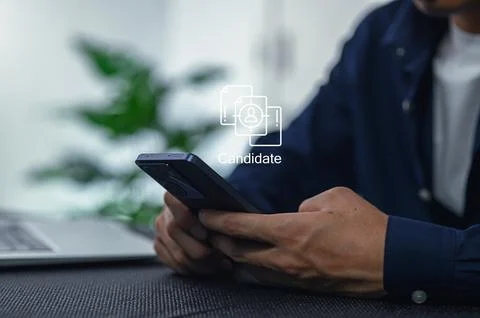 Candidate Using Smartphone for Job Application in Modern Office Setting Stockfoto's