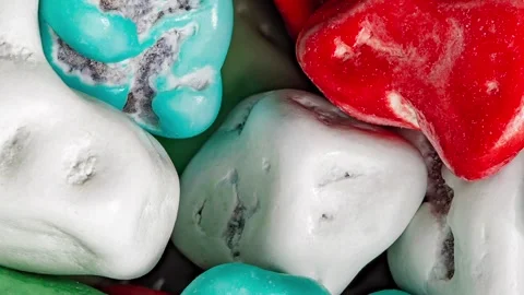 Candies in multicolored icing sugar, irregular form, rotating Video stock 255032427