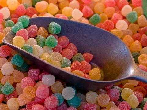 Candies with spoon Fotos de archivo