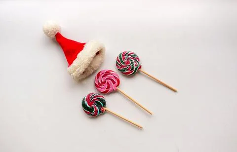 The candies on the white background.On the top of one candy is small Santa hat 스톡 사진