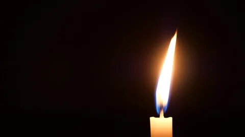 A candle alone burning in the dark. Stock Footage 127998879