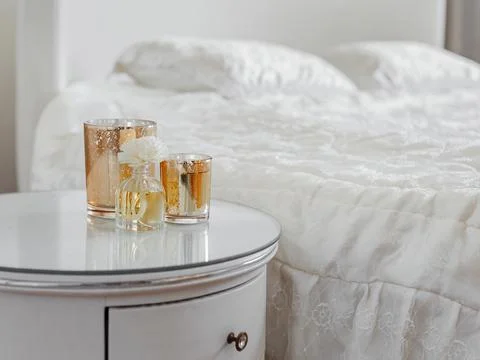 Candle and aroma diffuser on the bedside table in gold clouse up Stock Photos