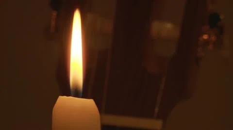 Candle and classical guitar on background. Stock Footage 10609172