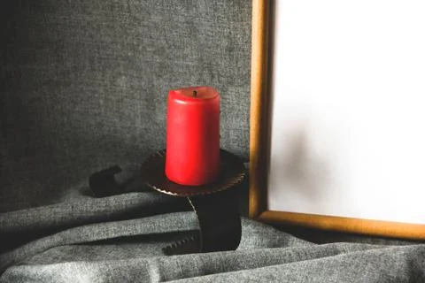Candle and frame on a gray background. Red candle Stock Photos