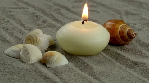 Candle and seashells on the sand Stock Footage 59620324
