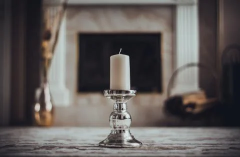 Candle on the background of the fireplace Stock-Fotos