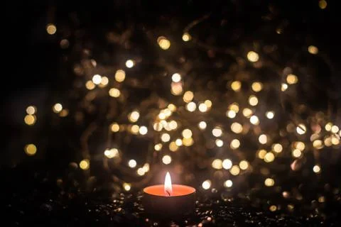 Candle on the background of the lights Stock Photos