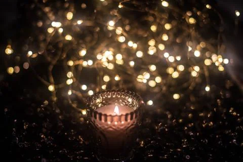 Candle on the background of the lights Stock Photos