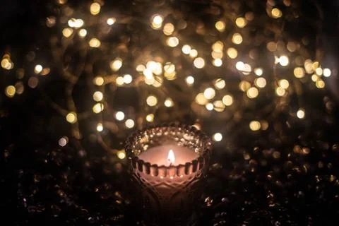 Candle on the background of the lights Stock Photos