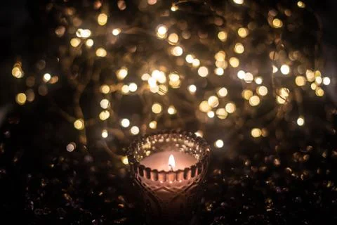 Candle on the background of the lights Stock Photos