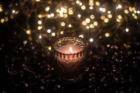 Candle on the background of the lights Stock Photos