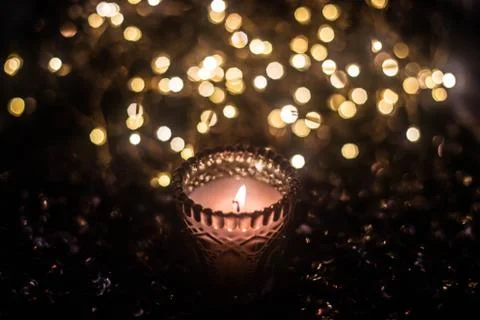 Candle on the background of the lights Stock Photos