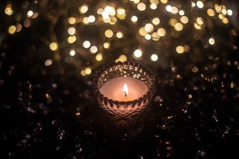 Candle on the background of the lights Stock Photos