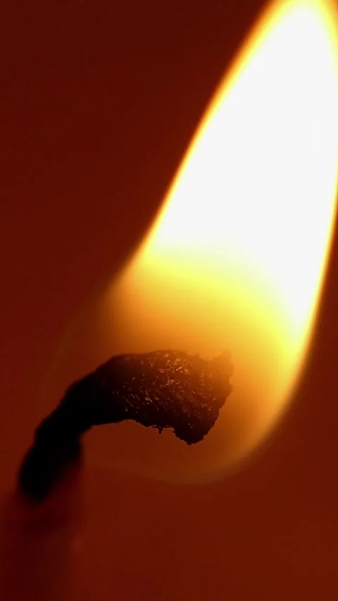 A candle beeing lit slow mo close up vertical 4k 30fps video Stock-Footage 299755046