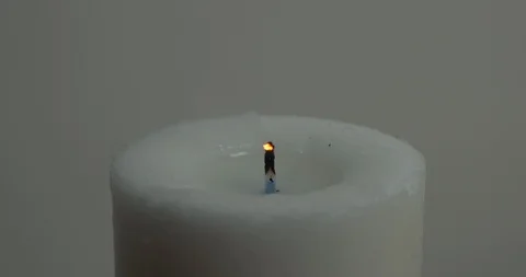 Candle being extinguished or blown out. With white wall in background. Stock Footage 129966555