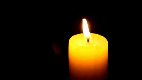 Candle being lit and extinguished by the wind in the darkness Stock Footage 77862406