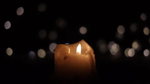 Candle on black background with blurring lights Stock Footage 295815097