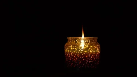 Candle on a black background. Candle in a candlestick in a dark room. Stock Footage 123055918