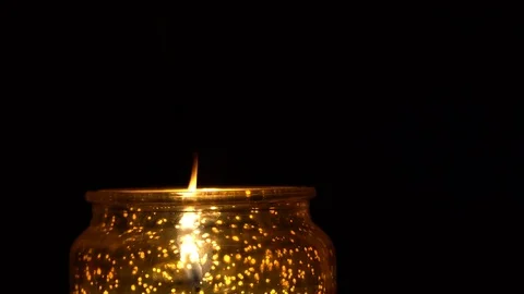 Candle on a black background. Candle in a candlestick in a dark room. Stock Footage 123055921