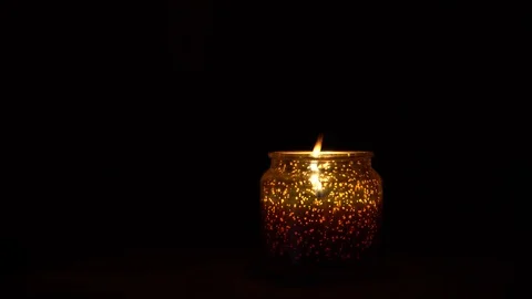 Candle on a black background. Candle in a candlestick in a dark room. Stock Footage 123059997