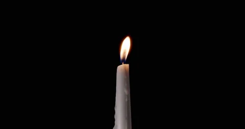 Candle on a black background. The flame of the candle slowly flickers. One Stock Footage 167650696