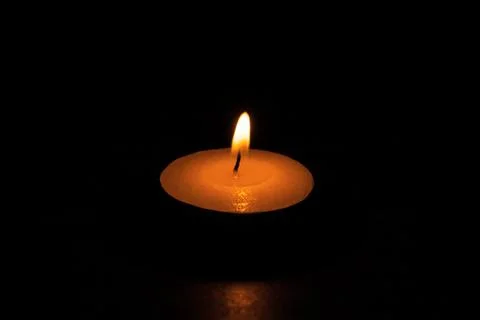 Candle on the black background Stock Photos