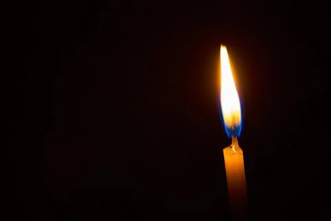 Candle on a black background Stock Photos