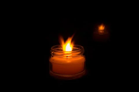 Candle on a black background. Stock Photos