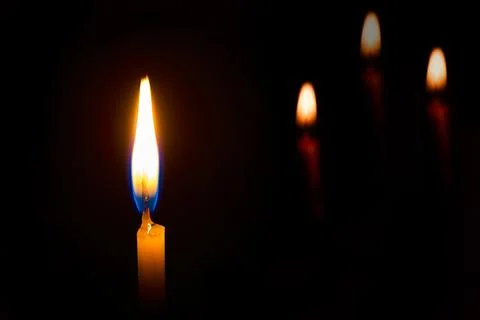 Candle on a black background Stock Photos
