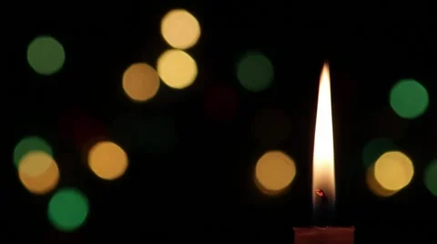 Candle with black background that is seen Christmas lights 5 Stock Footage 59654778