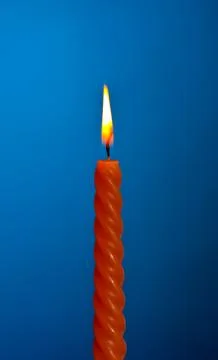 Candle on blue Stock-Fotos