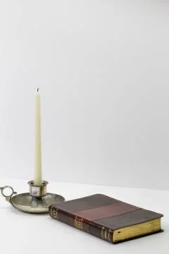 Candle with book Stock Photos