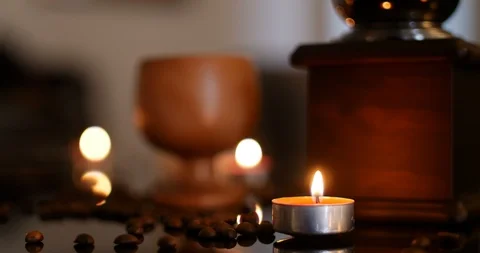 Candle burning with blurred background containing fresh roasted coffee beans, Stock-Footage 104407590