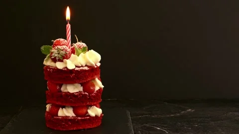 The the candle is burning on cakes mini cake red velvet with strawberry . The Stock Footage 163925869
