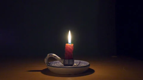 Candle burning on a candle holder Stock Footage 34857682
