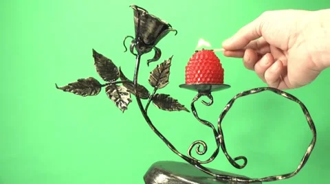 Candle burning on a candlestick on a green background Video stock 1079398