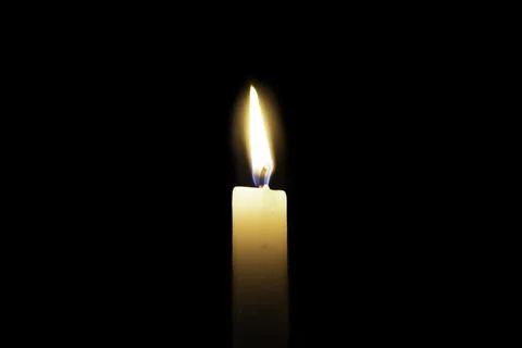 Candle is burning on a dark background Stock Photos