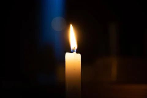 Candle is burning on a dark background Stock Photos