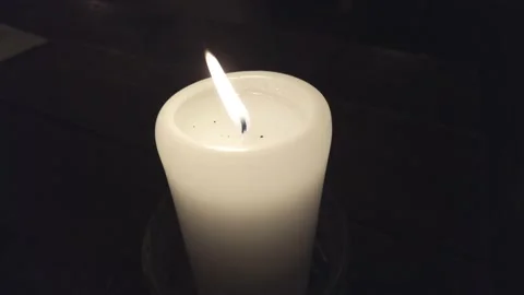 Candle burning in a dark room Stock Footage 169358283