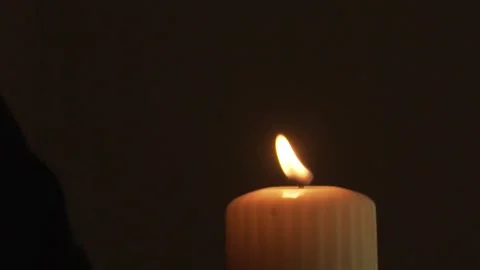 Candle burning in darkness (black background) Stock Footage 250542130