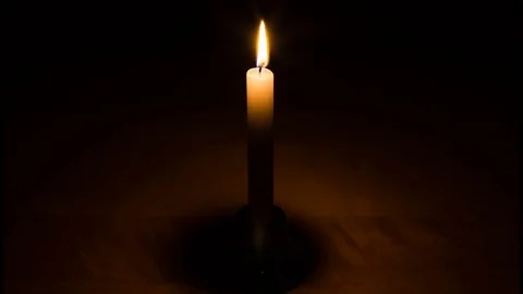 Candle burning in the darkness Stock Footage 73578040