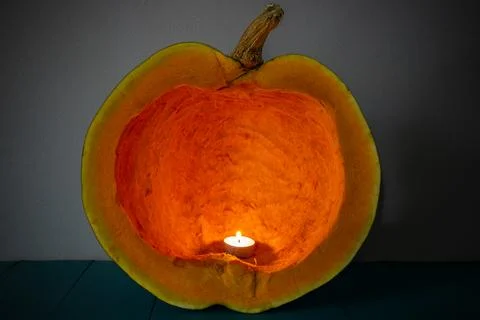 Candle burning inside a cleaned pumpkin, carved interior , abstract texture.. Stock Photos