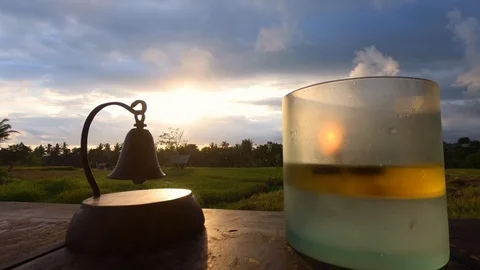 A candle is burning on the table at sunset. Stock Footage 102058991