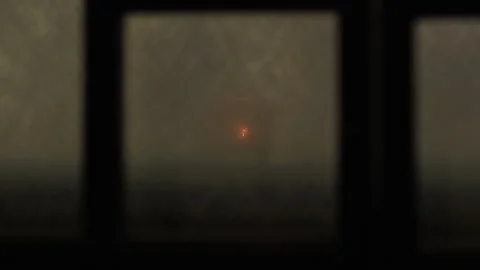 Candle burning though window as person walks by Stock Footage 161810784