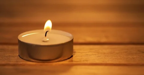 Candle burning on the wooden table Stock Footage