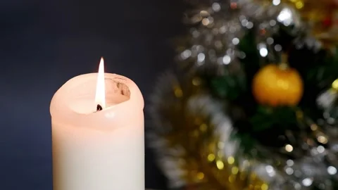 A candle burns against the background of a decorated Christmas tree. Christmas. Stock Footage 166316896