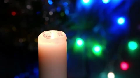 A candle burns on a blurred dark background with burning lanterns. Stock Footage 168822011