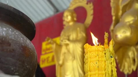 A candle burns in the Budi temple Stock Footage 222043711